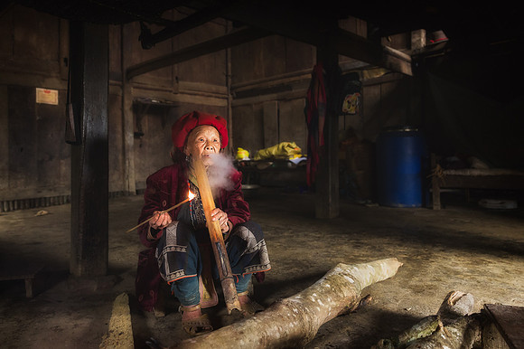Red Dao Woman smoking Pipe in Home